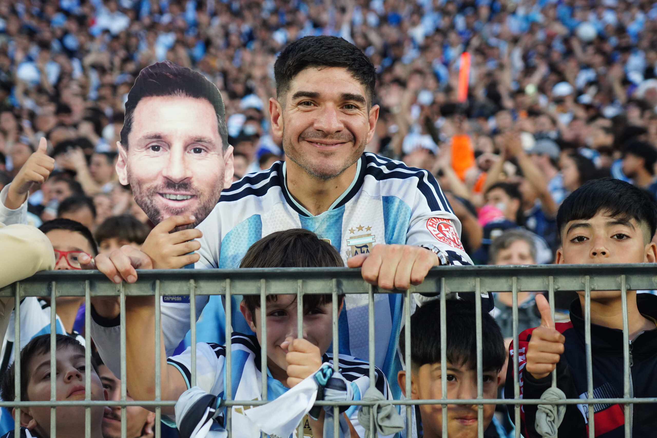 Hinchas con camisetas argentinas y una imagen de Messi antes del amistoso ante Benín.